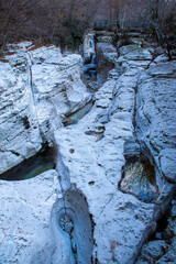 A Serene Riverbed Embedded Within a Rocky Landscape Surrounded by Natures Beauty