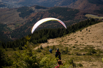 Paragliding in Ciucas mountains, Romania, during autumn season