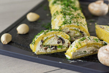 baked potato roll with cottage cheese filling with garlic and mushrooms, on a light wooden table