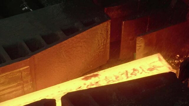 Metallurgical plant, foundry, red-hot billet in the form of a bar. Red-hot metal. Heavy industry. High Quality Steel Billets Manufactured