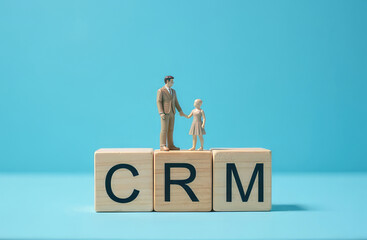 Customer relationship management concept, CRM. Human leadership reference wooden block on target icon, customer focus group, blue background. Data exchange development service. Hire new employee