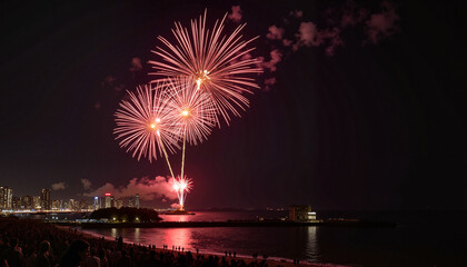 Colorful fireworks exploding over the coastline at night, festive atmosphere, celebrating an event