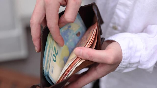Counting money in a wallet. Euro banknotes. 4K stock slow motion video. High resolution, high quality