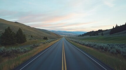 Fototapeta premium Serene Open Road Journey Through Scenic Landscape Under Soft Light of Dawn with Rolling Hills and Lush Greenery on Either Side
