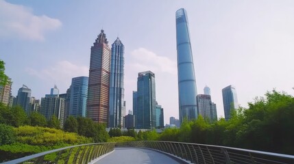 Obraz premium Modern Urban Skyline with Towering Skyscrapers Surrounded by Lush Greenery in a Contemporary City Landscape Captured on a Clear Sunny Day