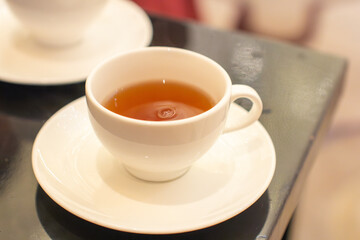 a cup of tea with a saucer that says  tea  on it.