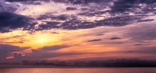 Sky Sunset in Autunm Background,Orange,Purple Sunrise with cloud over sea beach in Winter morning, Summer Dramatic majestic scenery.Seasacpe golden hour with colouful sunlight in evening