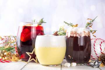 Hot drink cafes menu background, with mulled wine, eggnog and hot chocolate traditional Christmas winter cocktails and beverages, with Christmas New Year festive holiday decorations, copy space