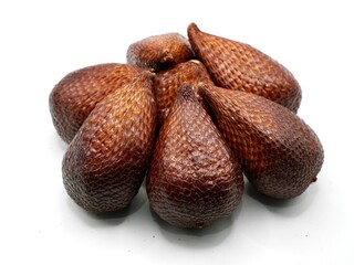 A close-up of fresh salak fruit, also known as snake fruit, displayed on a clean white background