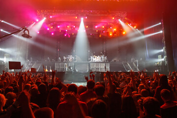 Crowd of people waiting for concert. Disco in nightclub. People look at stage waiting for musicians...