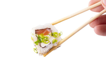 one piece raw salmon sushi with cream cheese held by chopsticks isolated