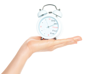 Woman hand holds white Alarm Clock, isolated on transparent background, time and home things concept