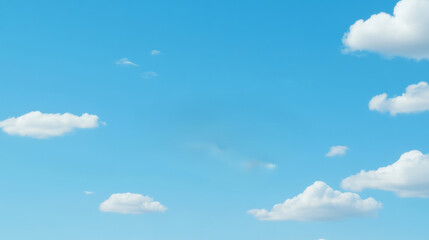 Fluffy white clouds float across bright blue sky, creating serene and peaceful atmosphere
