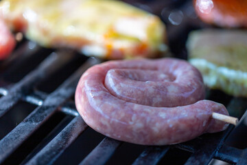 Pork steak and snails bratwurst on the grill grate