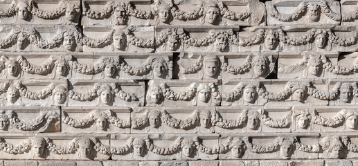 Ancient stone relief featuring theatrical masks and ornate garlands from Aphrodisias, classical art. Ancient Aphrodisias city, Geyre, Aydin, Turkey (Turkiye)