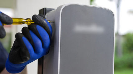 Qualified technician install home EV charging station, providing maintenance service for electric...
