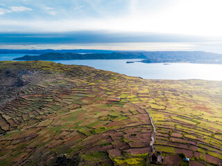 Aerial view of crop fields and Lake Titicaca from Amantani Island in Puno, Peru
