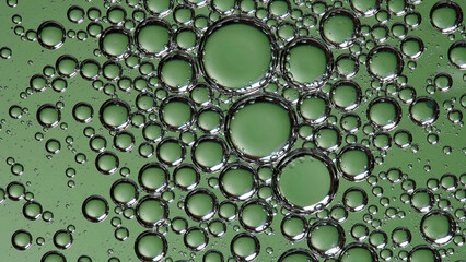 Beautiful bubbles in liquid, with a green background. Macro shooting