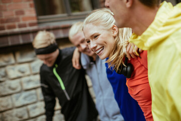 Young people walking on a city street after jogging in the city