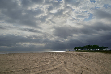 Deserted beach and grey sky on the horizon