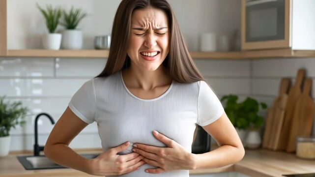 Middle-aged woman clutching her chest in pain, highlighting heart attack symptoms in women