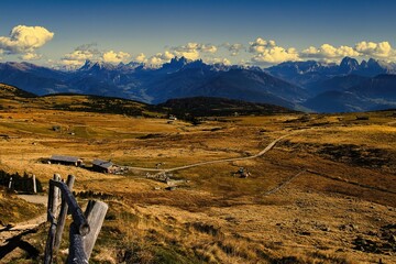 Dolomite mountains scenic view with rustic fence.