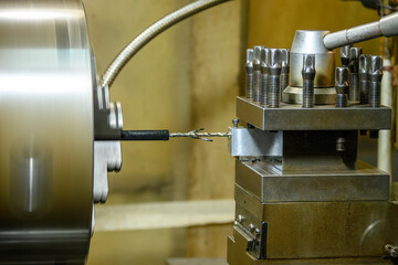 The lathe machine drilling process the metal parts.