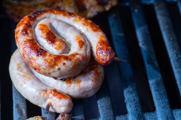 Pork steak and snails bratwurst on the grill grate