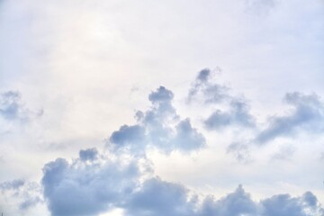 Bright daytime sky with fluffy gray clouds isolated on horizontal ratio outdoor environment background.