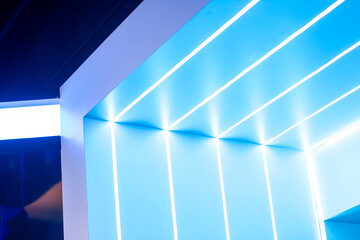 a blue wall with a bright light and a blue background.