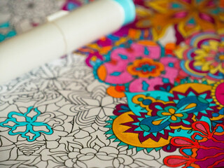 Colorful floral seamless floral pappern. Drawing made with vibrant alcohol markers. A marker laying on top of it.