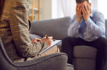 Sad man crying during a therapy session with a psychologist. This emotional moment highlights the man's sadness and the importance of seeking mental health support and guidance.