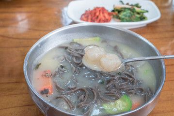 Korean Buckwheat Noodle Soup with Potato Dumplings (Ongshimi) and Fresh Green Kimchi
