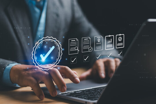 Certification and quality control standards, best quality assurance, guarantee Concept, businessman showing standard management with quality mark and accepting regulatory requirement on laptop
