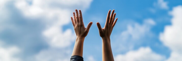 Obraz premium Two hands reach towards a bright blue sky, expressing freedom, joy, and the celebration of life in an uplifting outdoor setting filled with positive energy.