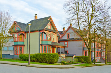 Neighbourhood of luxury houses in summer with street road, big trees and nice landscape in Vancouver, Canada. Blue sky. Day time on August 2024.