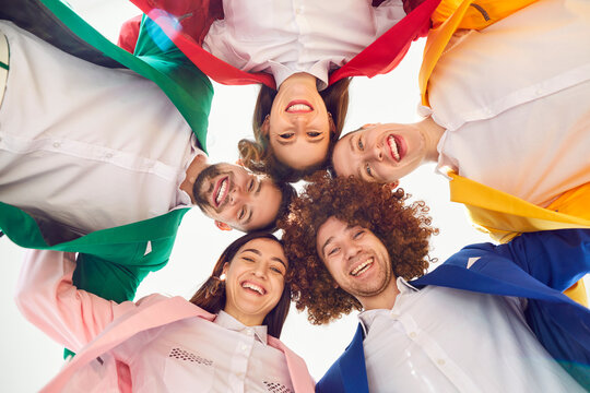 Heads together, group of smiling friends united to think, enjoy, business harmony, agreement. People in circle wearing vibrant vivid formal color suit, working together, life, team building support