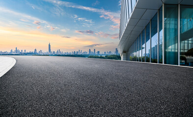 Empty asphalt road and cityscape with skyline in modern city