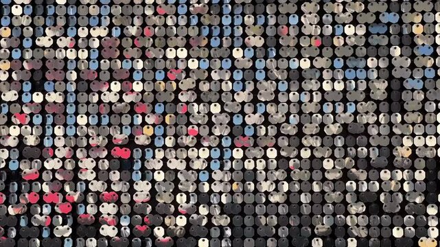 Abstract background with silver disco shiny on the wall. Flickering and glittering silver metallic particles or sequins backgrounds of sparkly reflectors suitable for holidays backdrop. 