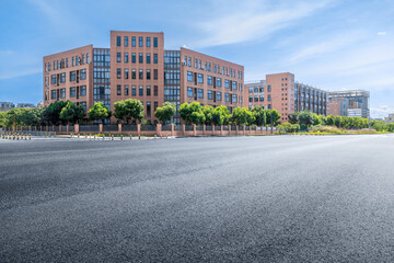 Empty asphalt road and school building in modern city © zhao dongfang