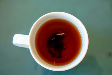 porcelain cup of tea on the glass table