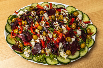 Fresh salad of cucumbers, peppers, beets, olives, cheese...