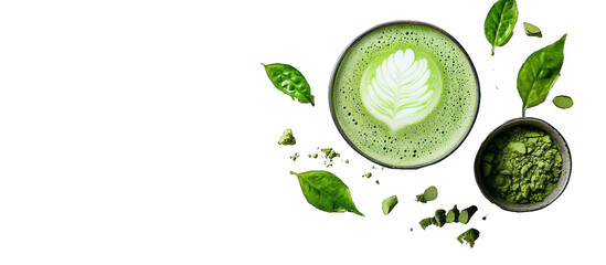 A frothy matcha latte with foam art, green powder, and matcha leaves, against a white backdrop.
