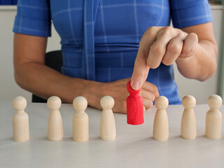 One other red human figurine among wooden figures