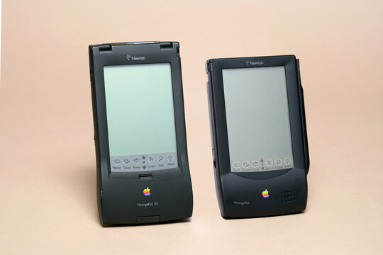 Pavia, Lombardy, Italy - October 12, 2024: two of the five Apple Newton Pad models produced, the 1993 MessagePad and the 1994 MessagePad 120, precursors to the iPhone. Shown at the CTRL+Alt Museum.