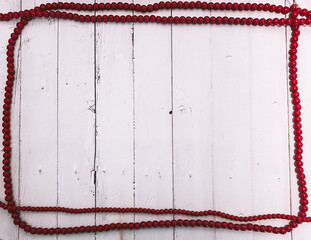 White background with Red Holiday Bead Garland in rectangular layout for flatlay design