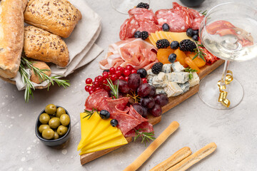 Party charcuterie board italian food antipasti prosciutto ham, salami and cheese appetizers served in the shape of a Christmas tree. party food for New Year's Eve, Christmas or birthday