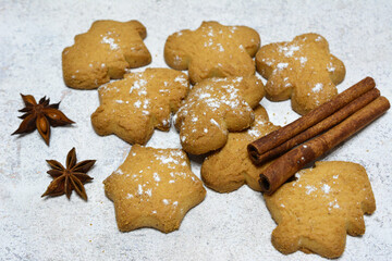 a pile of gingerbread cookies with star shaped cookies and cinnamon sticks on the top 