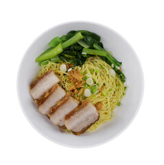 A bowl of noodles topped with slices of pork and green vegetables, showcasing a vibrant mix of textures and colors.