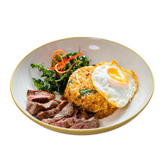 A delicious plate featuring fried rice with a sunny-side-up egg, savory beef slices, and fresh greens, garnished with colorful vegetables.